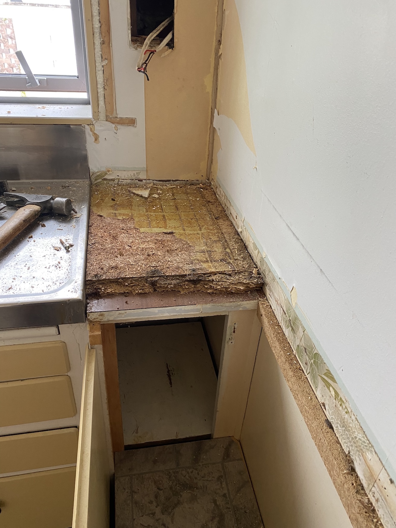kitchen demolition revealing damaged top bench Old kitchen demolition revealing damaged bench top