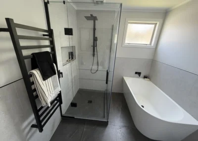 Spode bathroom renovation featuring a spacious tiled shower, freestanding bath and matte black fixtures